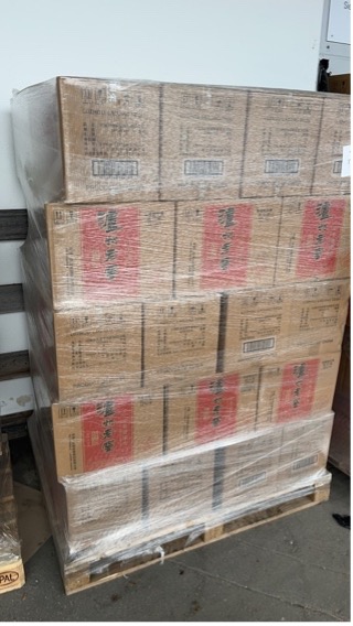 Stacked cardboard cartons on a wrapped pallet