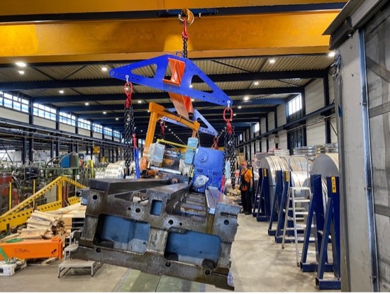 Industrial handling area with machinery and overhead cranes