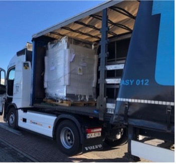 Truck with an open trailer side and wrapped pallet cargo