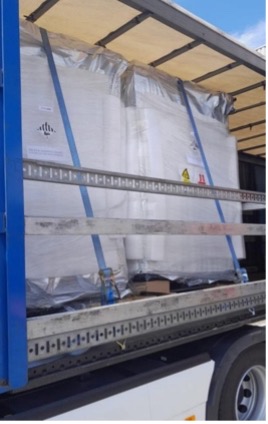 Wrapped pallets secured with straps inside a curtain-sided trailer