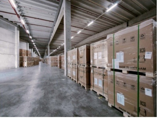 Warehouse aisle with stacked wooden crates