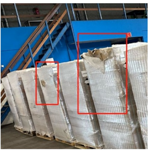 Damaged packaging marked in red during a cargo inspection