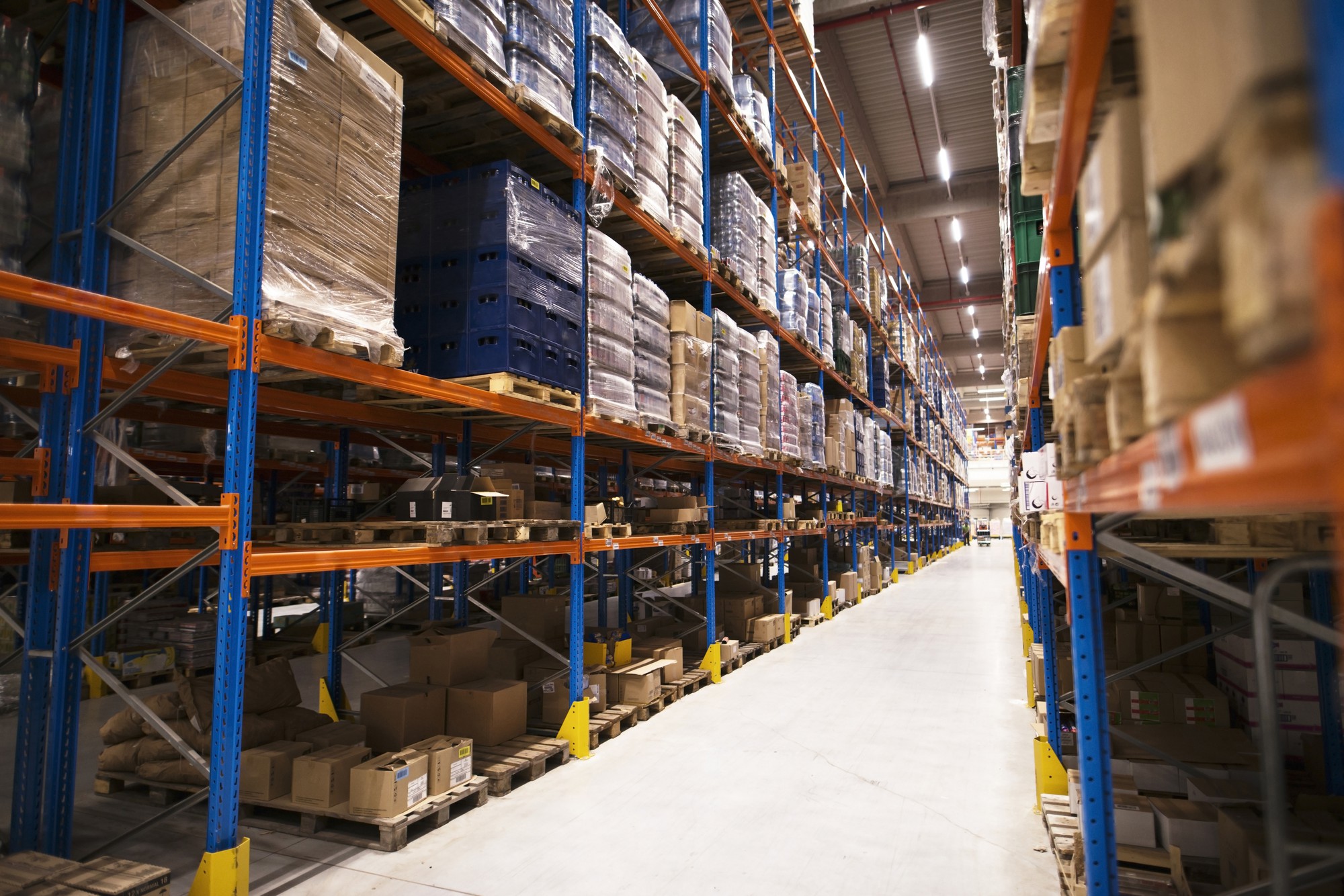 Warehouse aisle with pallet racks and stored goods