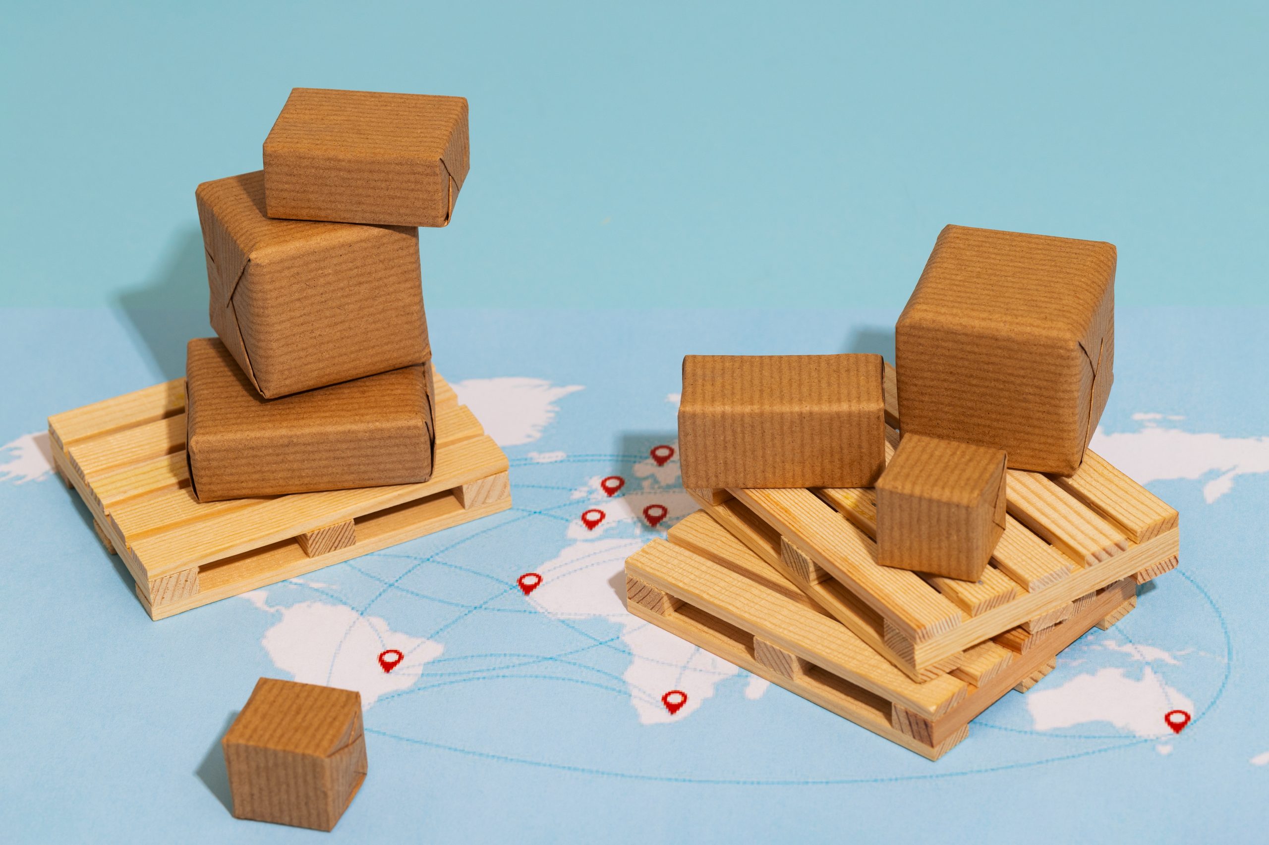 Miniature pallets of cardboard boxes on a map